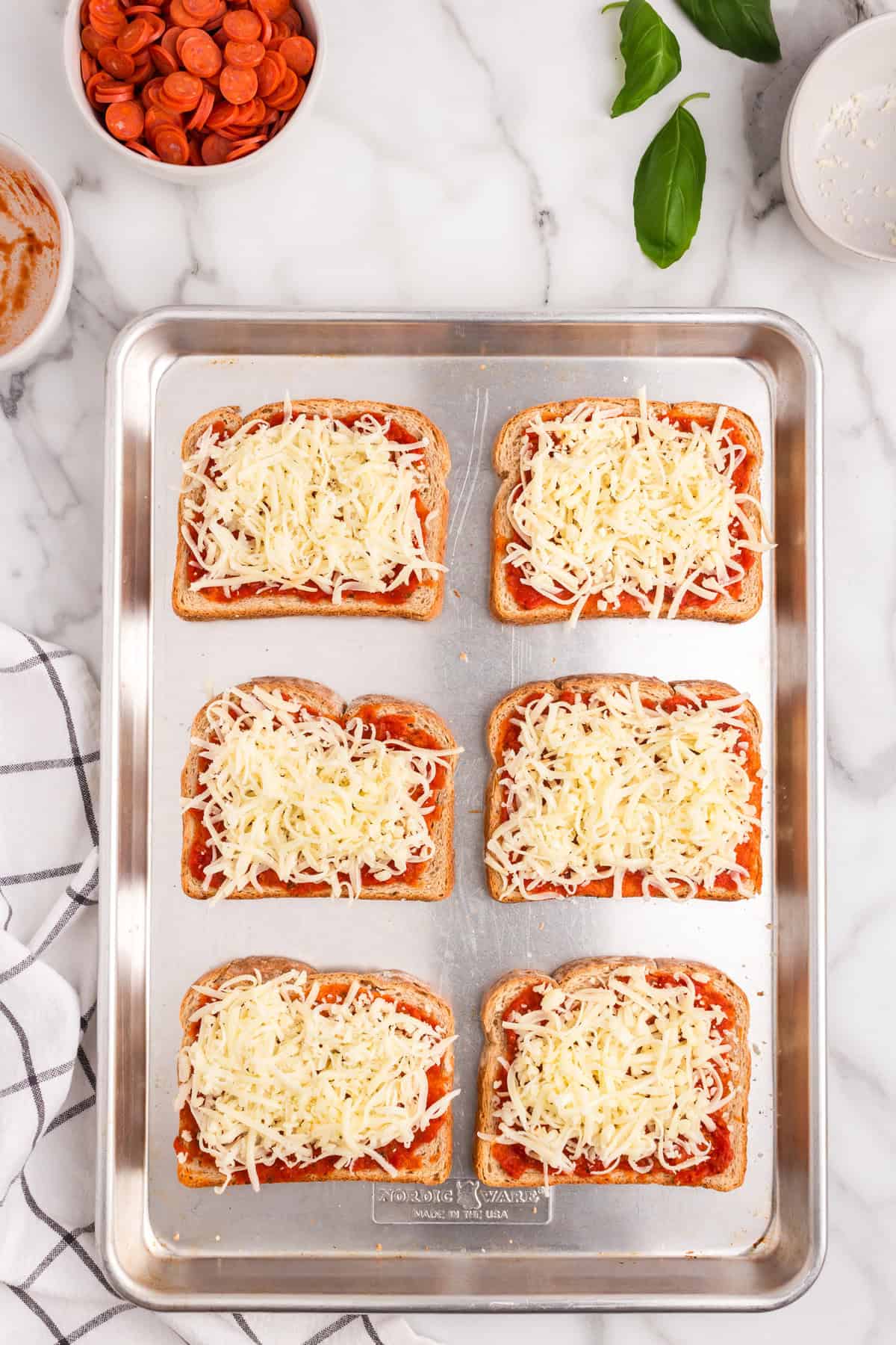 Add the Mozzarella cheese on top of the pizza sauce.