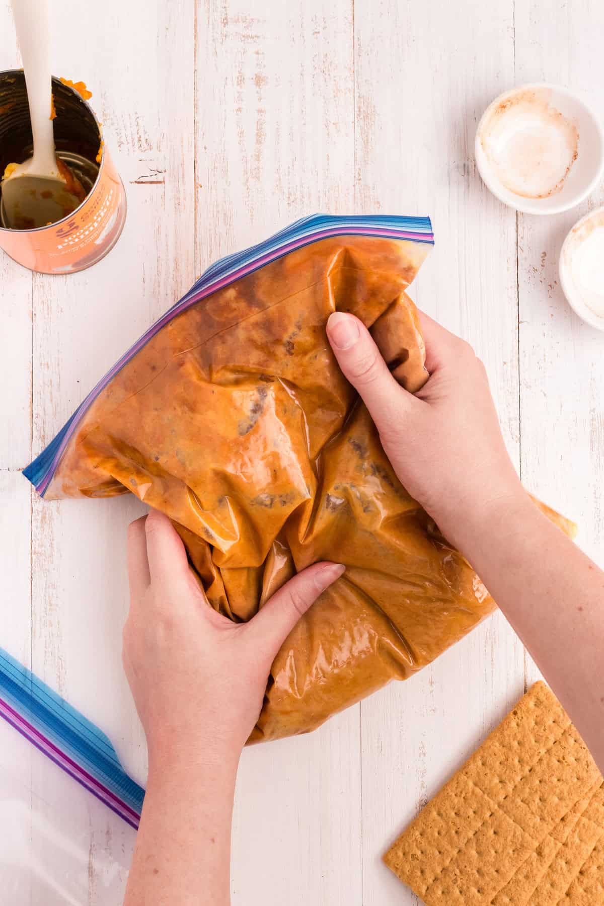 Kneading the spices into the The gallon zip lock opened to add the spices for the Pumpkin Pie in a Bag with the zip locks secured