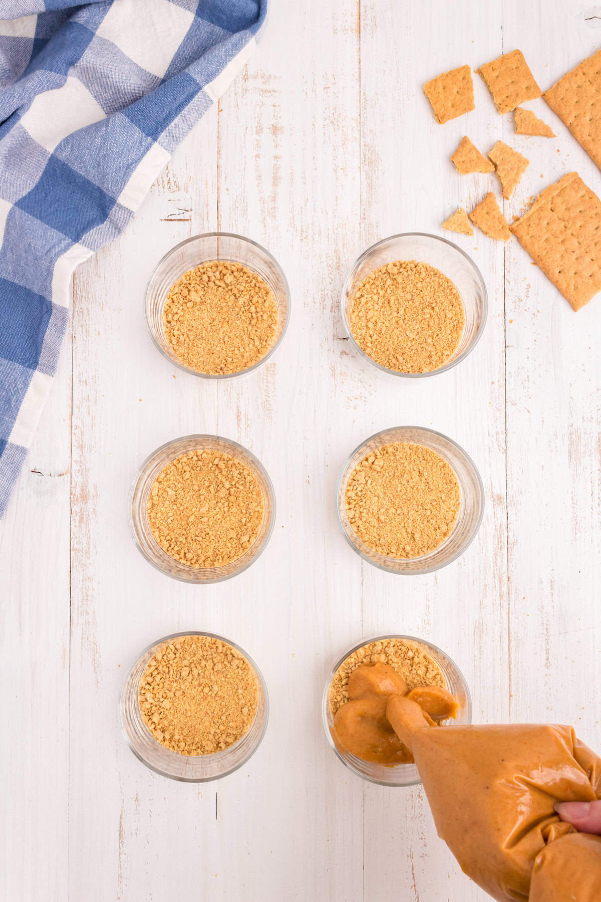 Crushed graham crackers in bottom of serving cups and piping in pumpkin mixture with slit cut in gallon bag for Pumpkin Pie in a Bag recipe