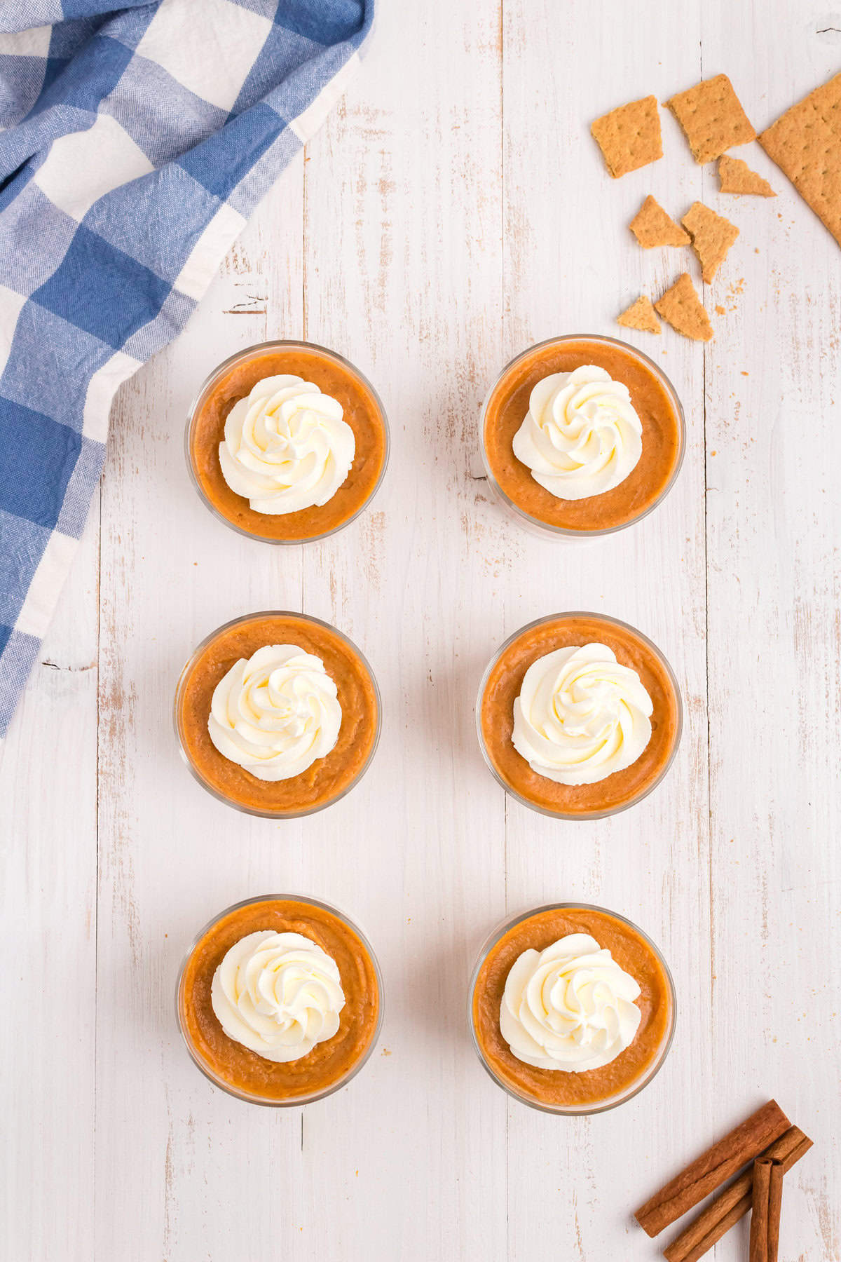 Adding dollop of whipped topping to Pumpkin Pie in a Bag in small serving cups