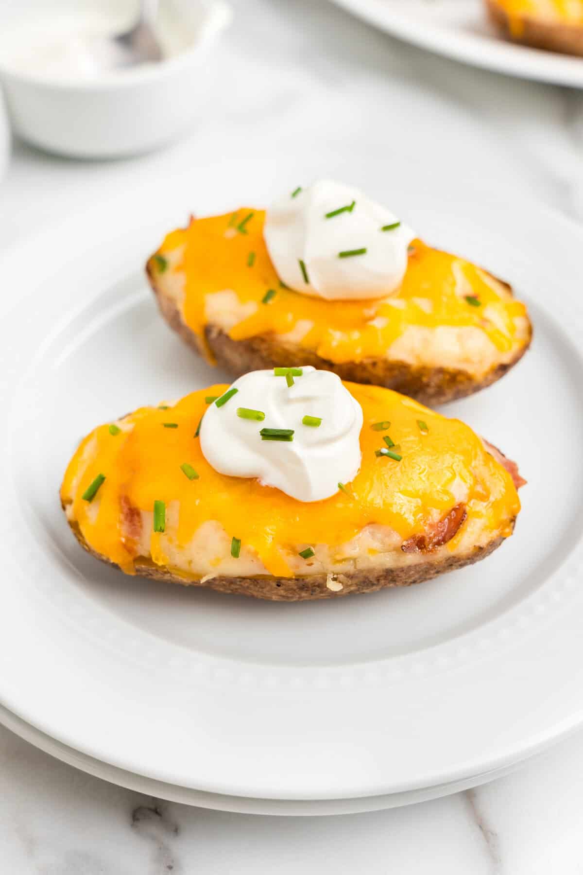 Adding a dollop of cream cheese and fresh chives to Twice Baked Potatoes