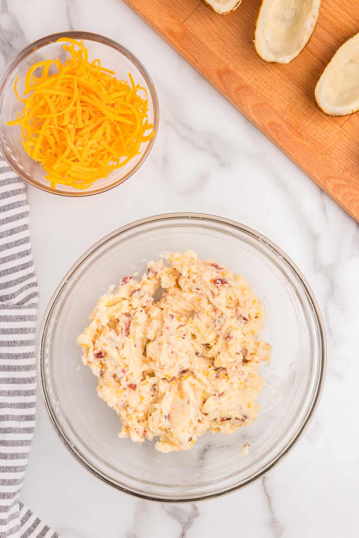 Ingredients for Twice Baked Potatoes in glass mixing bowl after combining