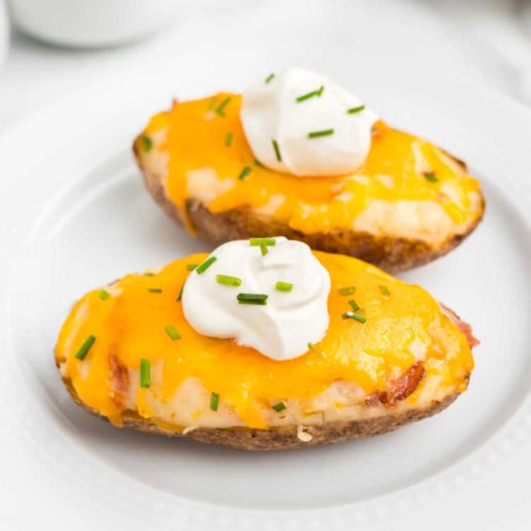 Closeup square image of Twice Baked Potatoes on plate