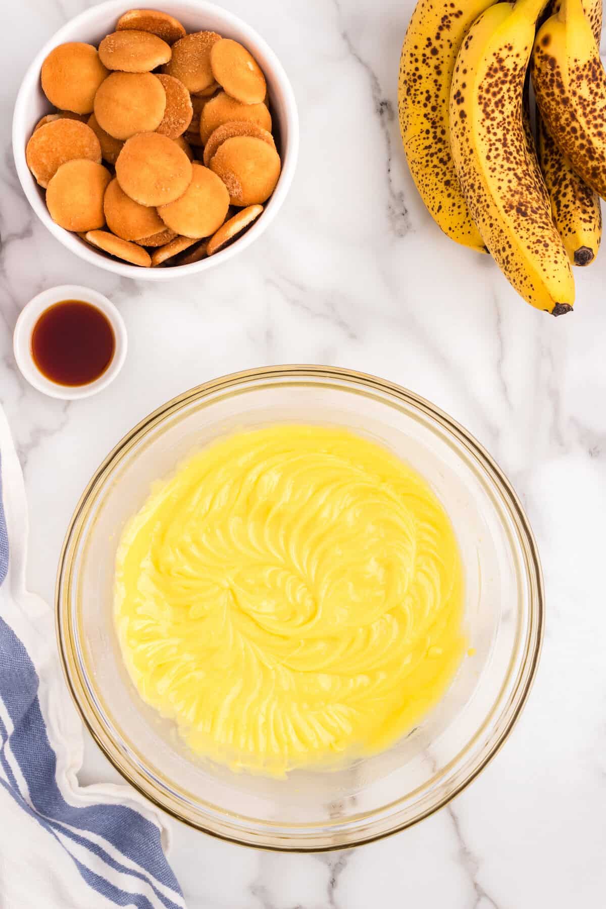 Combined ingredients for Banana Pudding in glass bowl