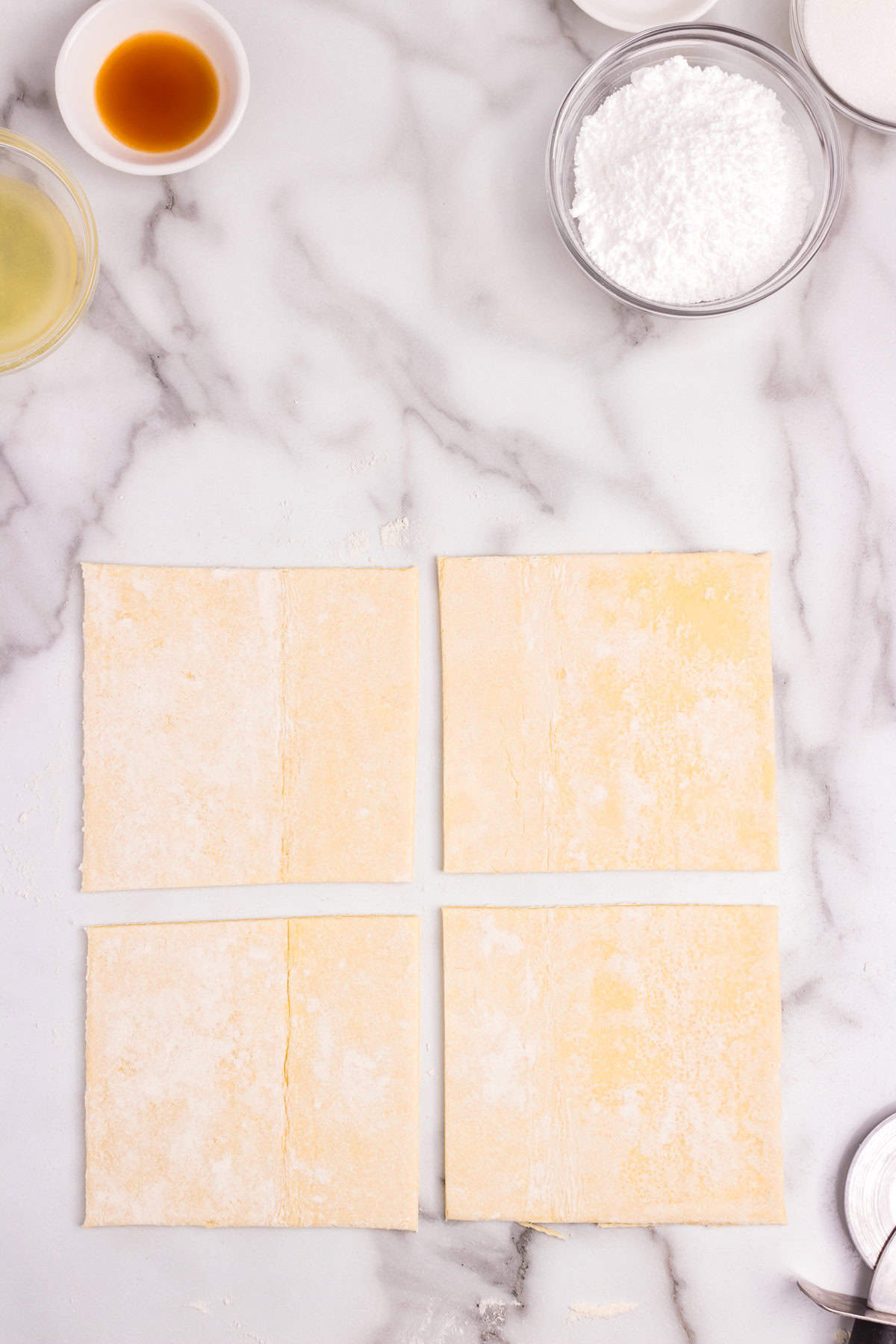 Cutting the puff pastry into equal quarters for the Cream Cheese Danish recipe