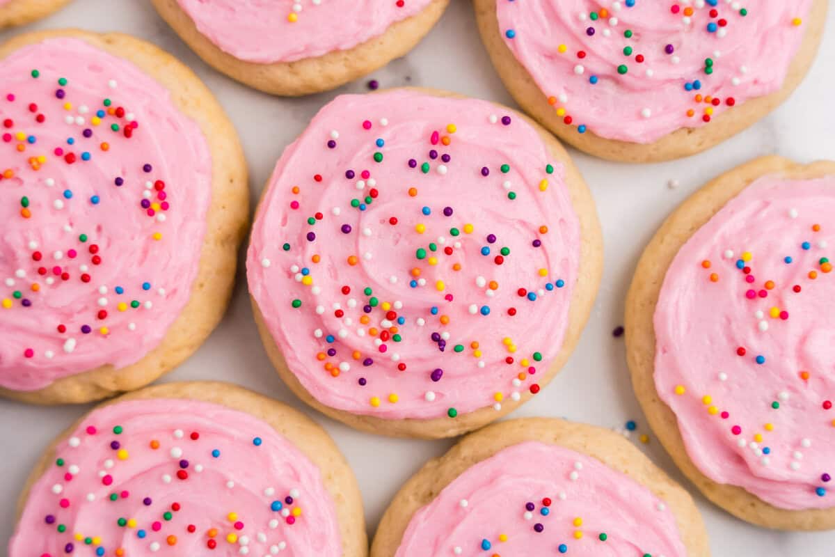 Sour Cream Cookies with homemade frosting and sprinkles arranged on serving platter