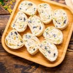 Slices of tortillas pinwheels on wooden square plate