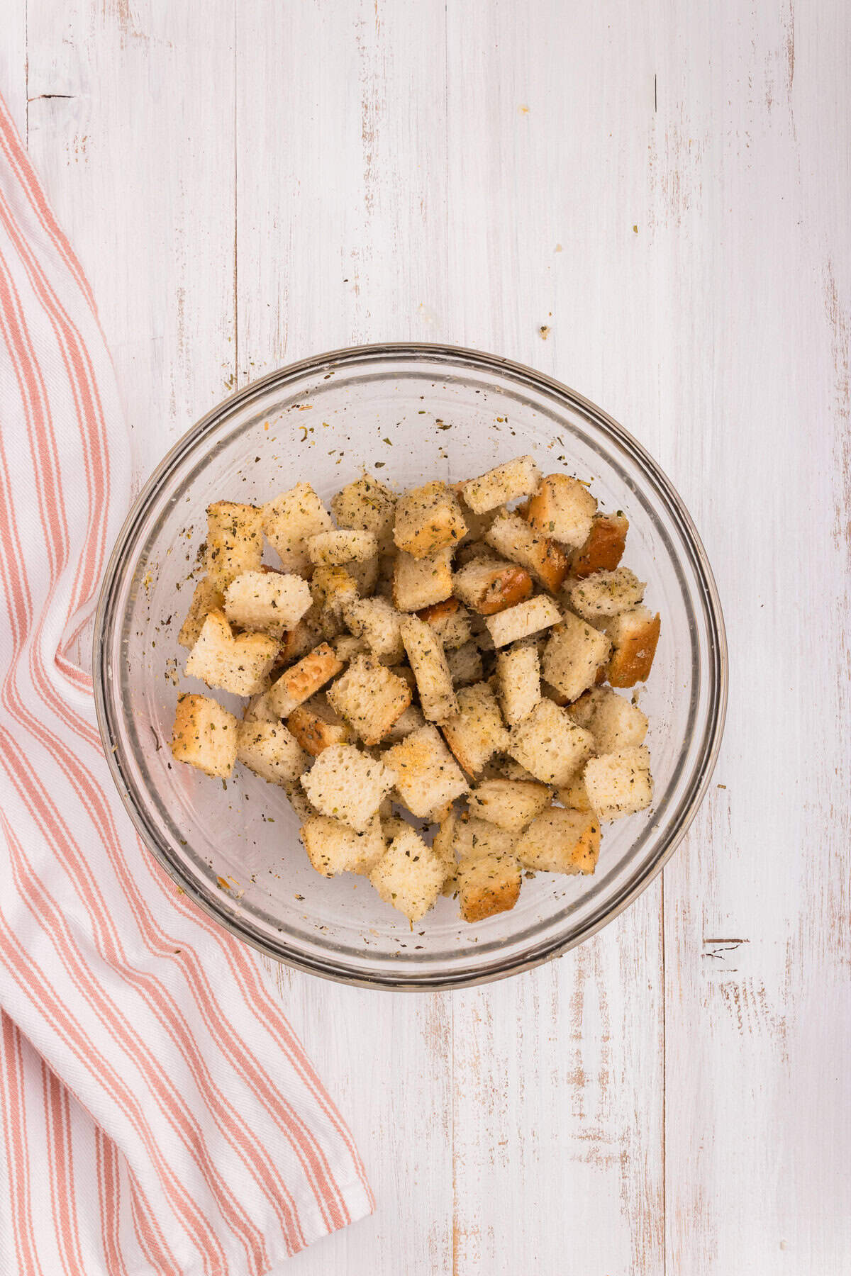 Tossed coated bread cubes in glass bowl for Air Fryer Crouton recipe