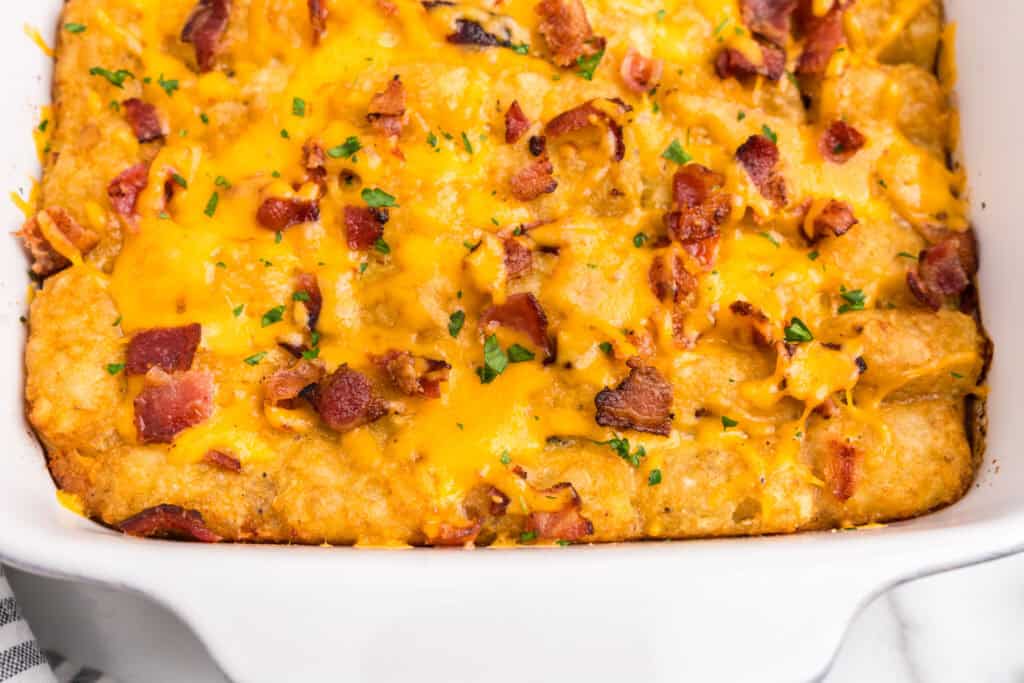 Close up of cooked tater tot breakfast casserole in white pan
