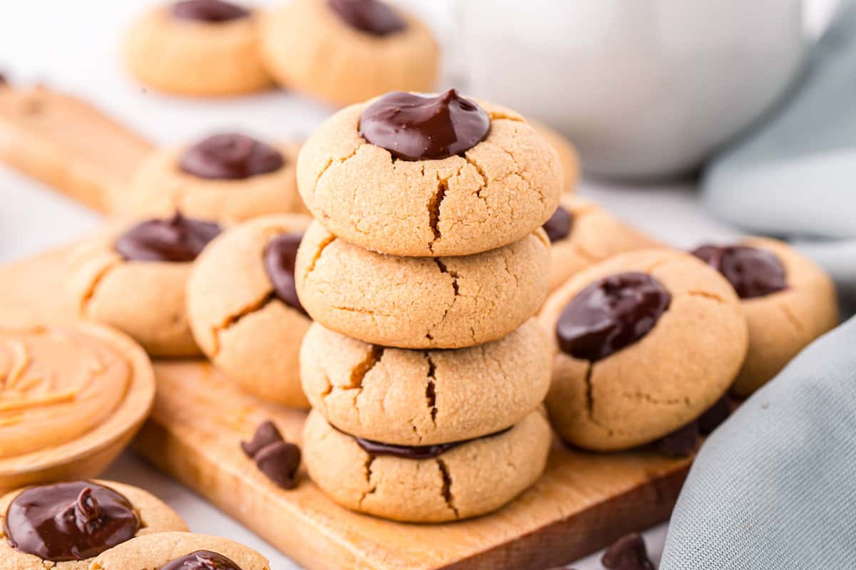 Chocolate Peanut Butter Thumbprint Cookies stacked on serving tray