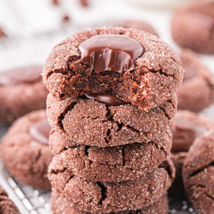 Closeup image of Chocolate Thumbprint Cookies stacked with one bite taken