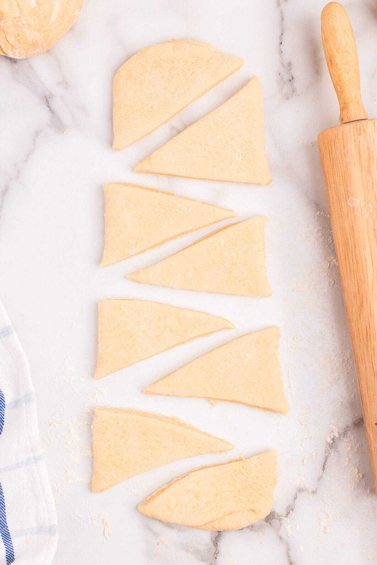 Rolled out Homemade Crescent Rolls dough cut into triangles