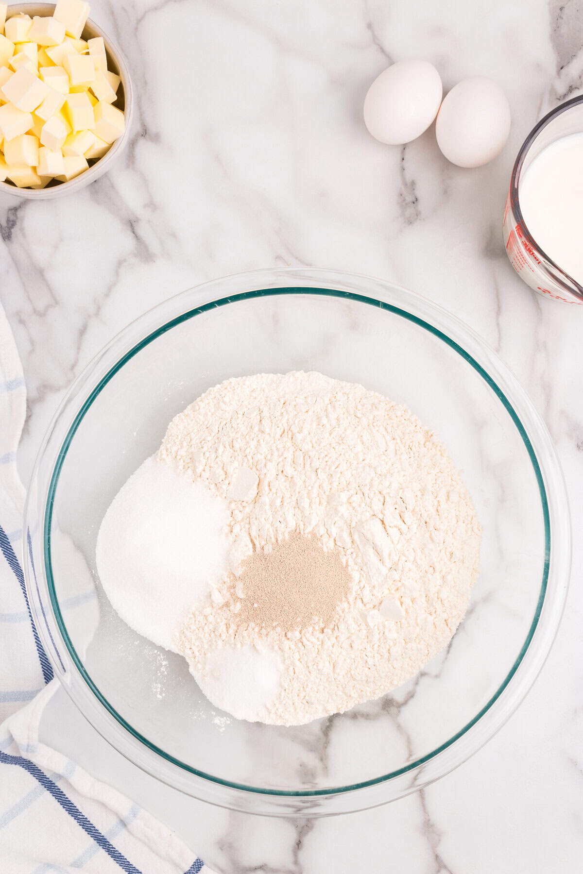 Dry ingredients for Homemade Crescent Rolls in glass mixing bowl