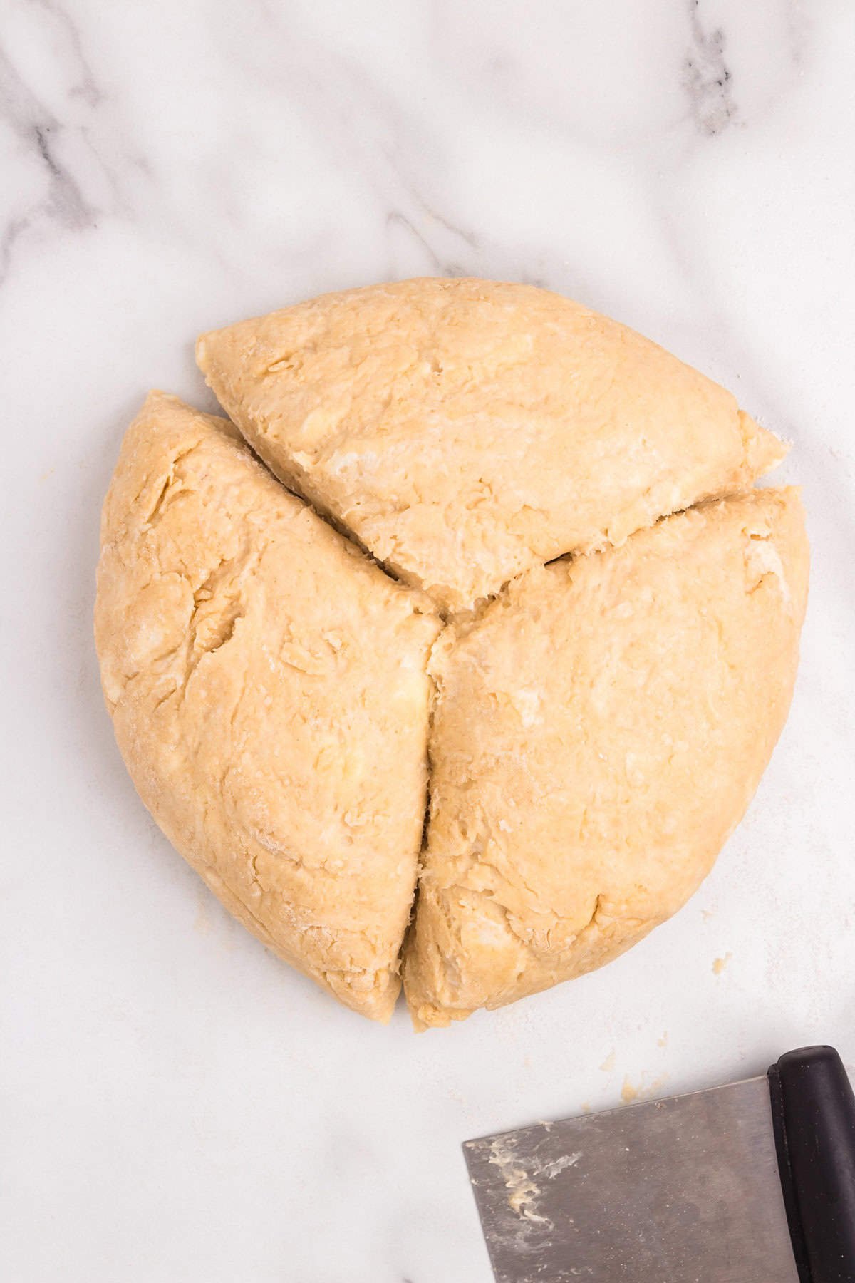 Homemade Crescent Rolls dough ball cut into thirds
