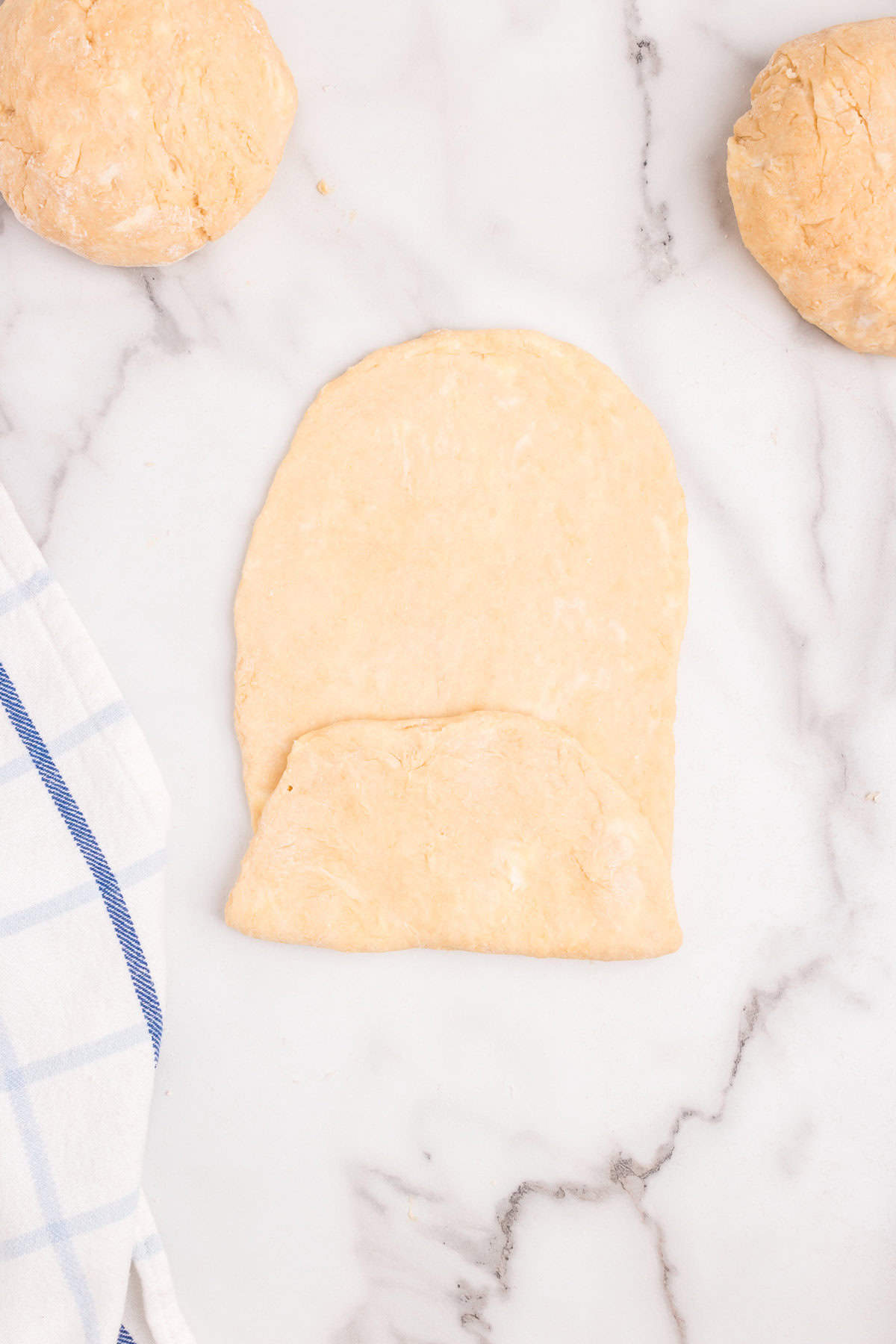 Rolled out Homemade Crescent Rolls dough folded into thirds