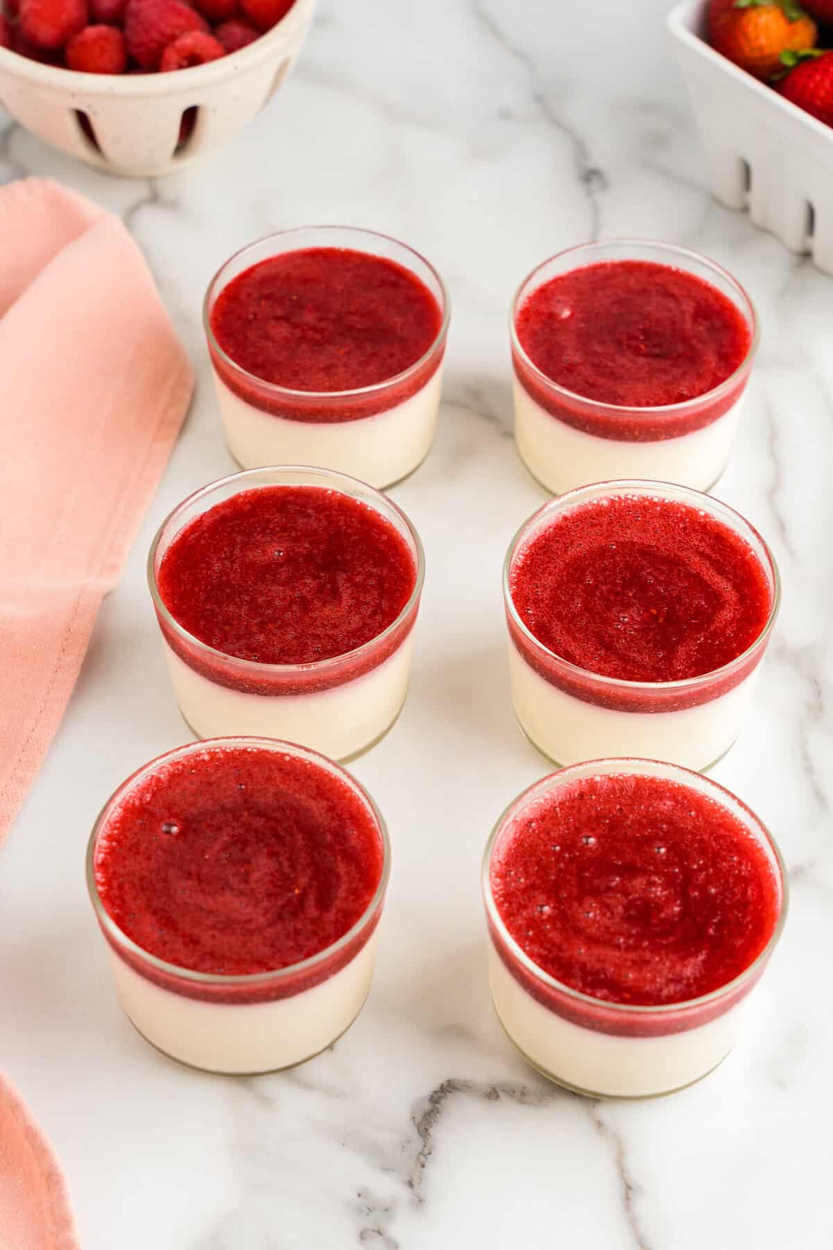 Topping the Swedish Creme cups with berry compote