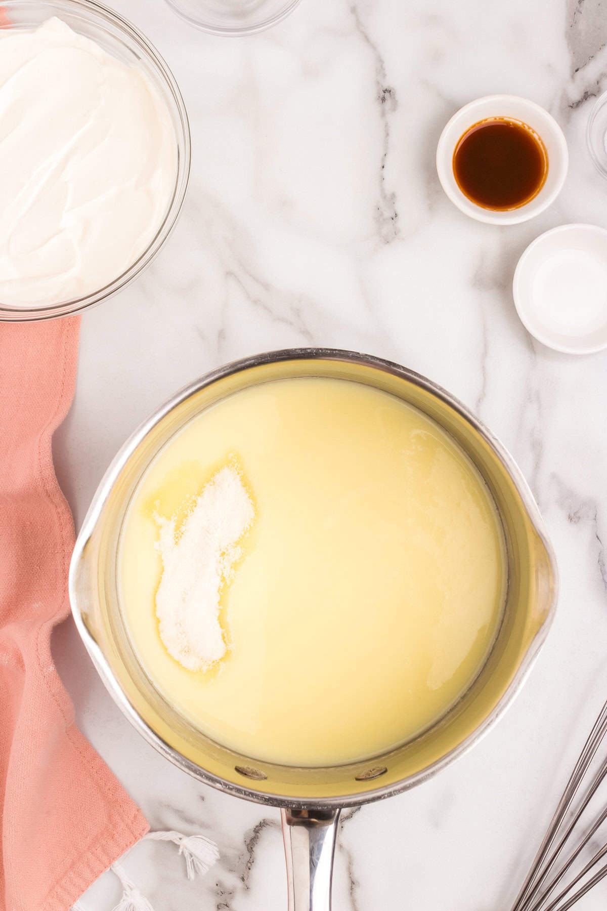 Adding ingredients to Swedish Creme base in saucepan