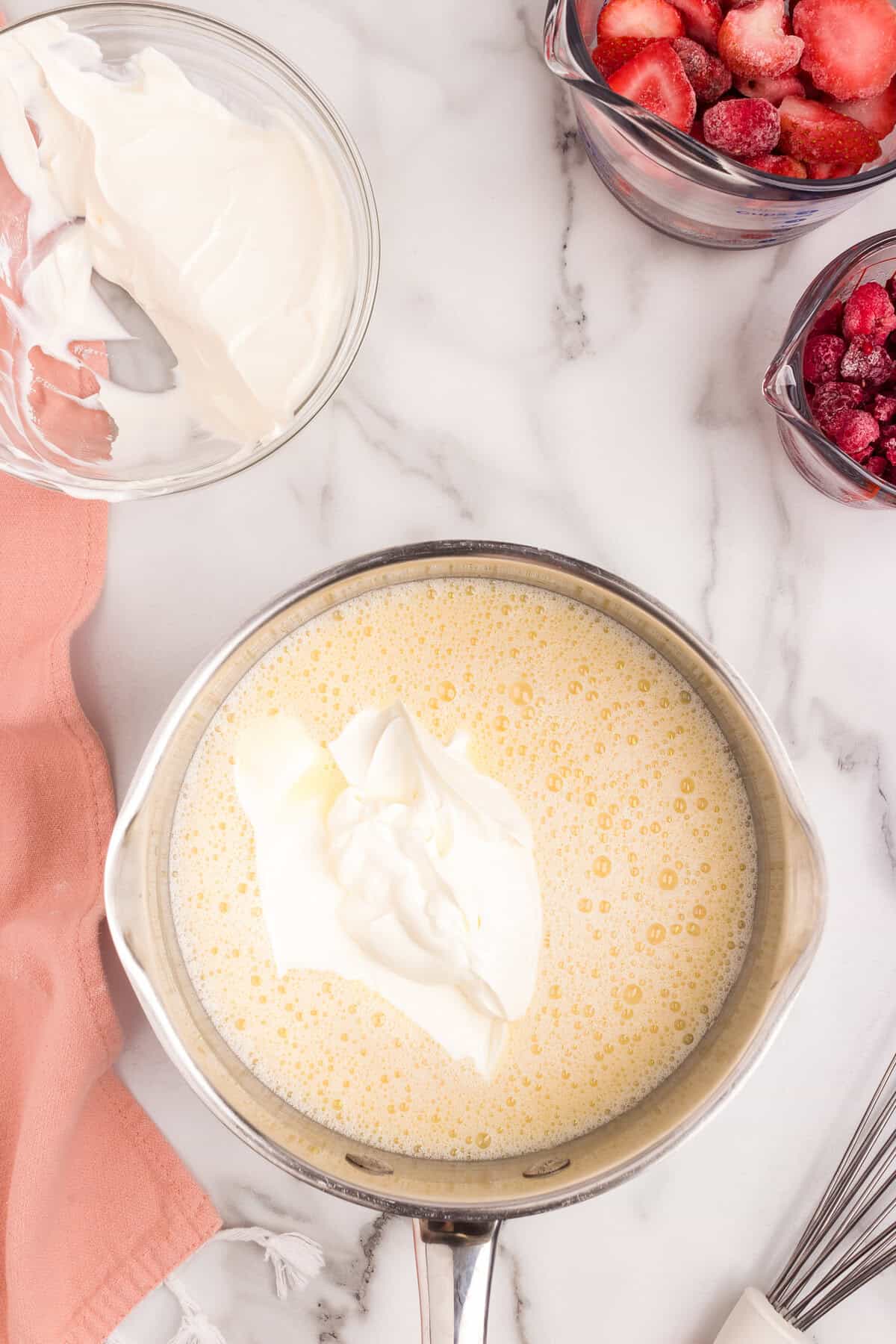 Adding ingredients to saucepan for Swedish Creme