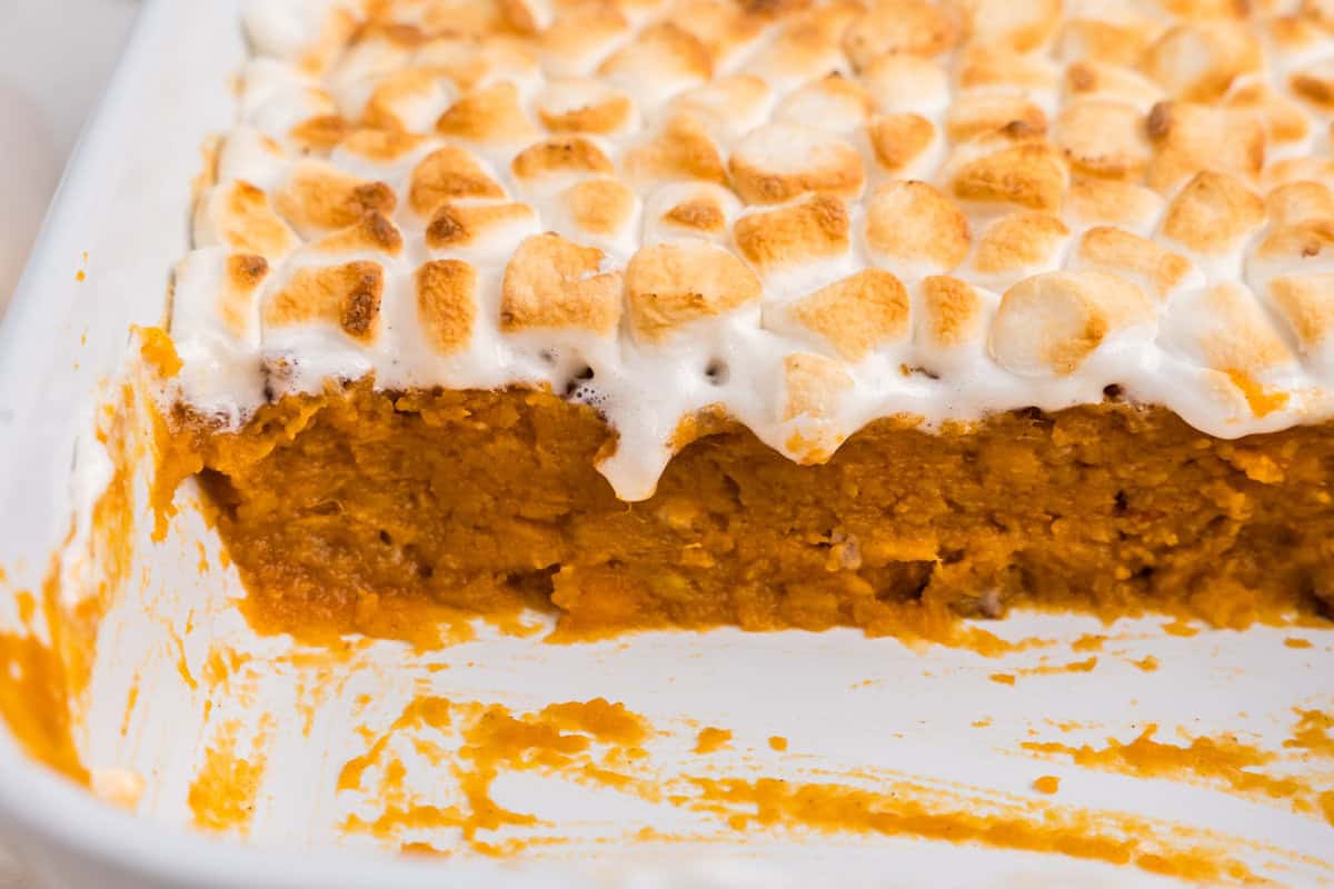 Close up side profile picture of sweet potato casserole layers.