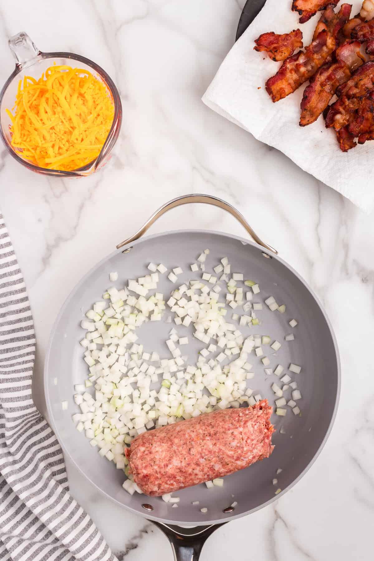 Overhead picture of sausage and onions in frying pan