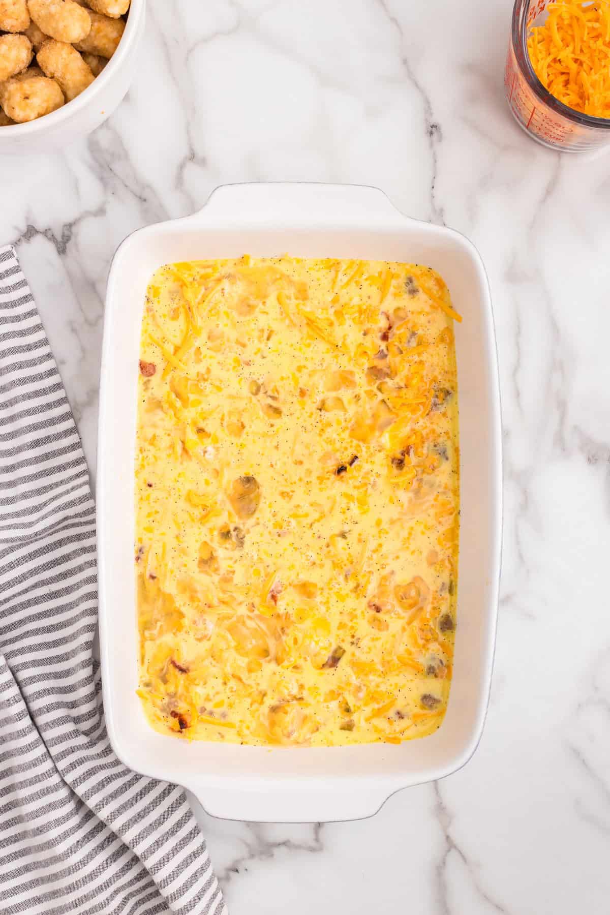 Overhead picture with eggs layered in white pan