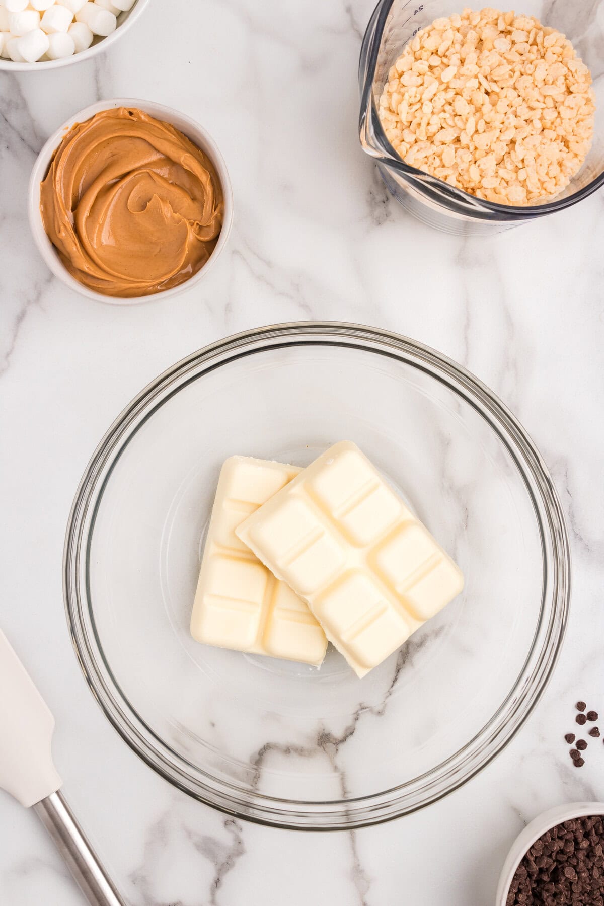 White chocolate bark pieces in small glass mixing bowl for Avalanche Cookies recipe