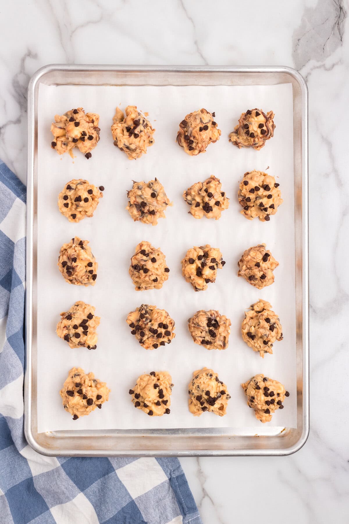 Avalanche Cookies dollops on parchment-lined cooking sheet