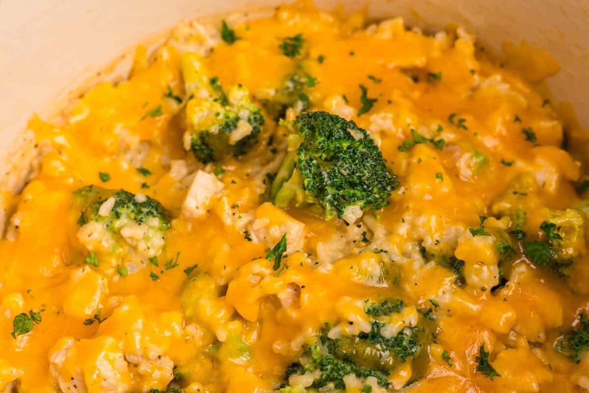 Close up image of completed cheesy chicken broccoli and rice casserole in it.