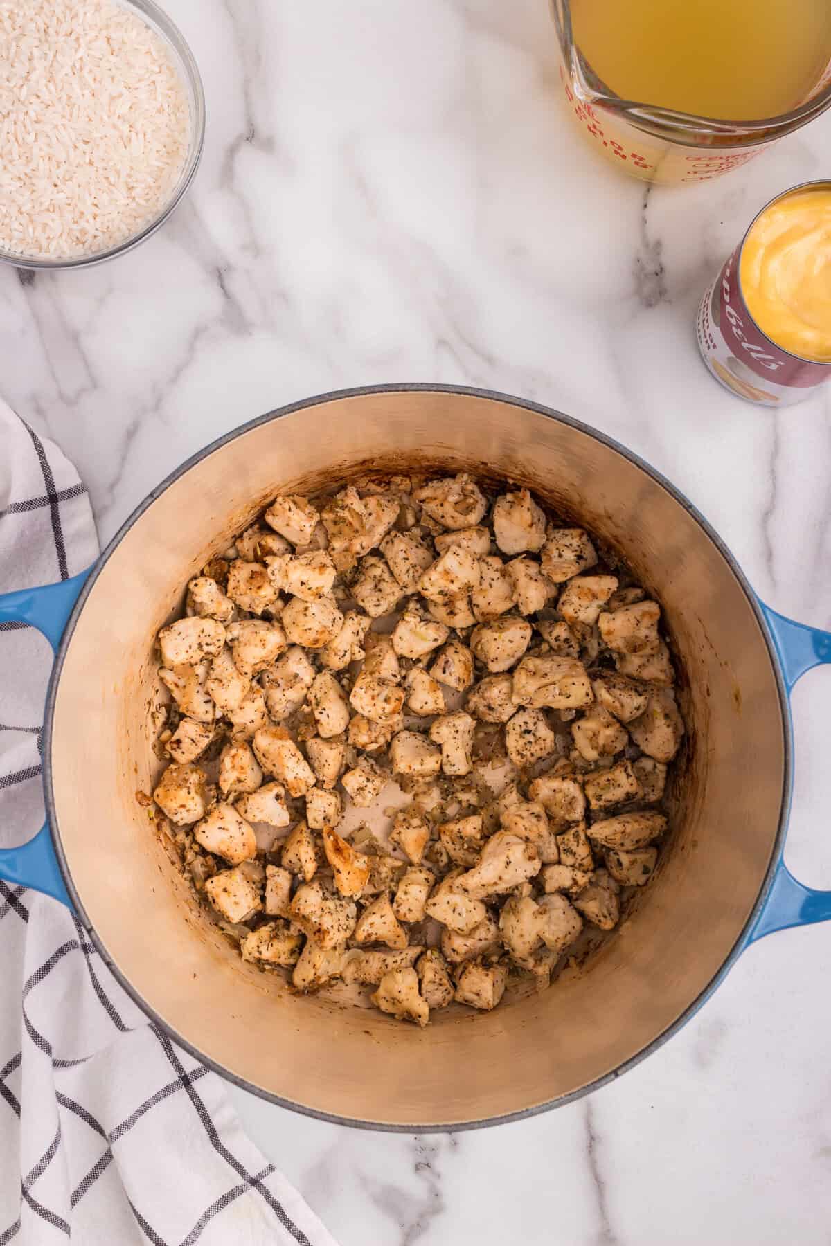 Overhead picture of dutch oven with cooked chicken in it.