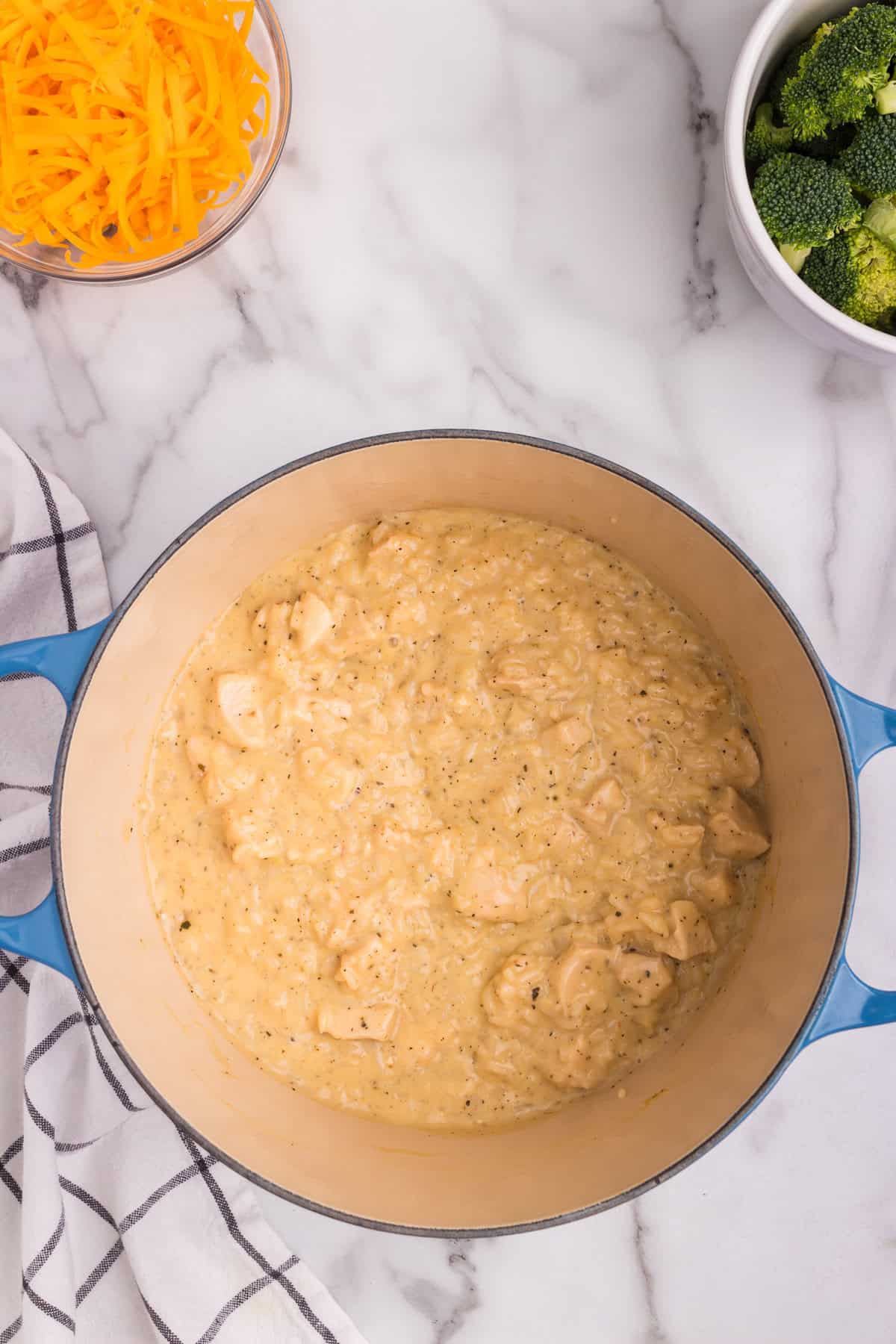 Overhead picture of dutch oven with cooked chicken and cream mixture in it.