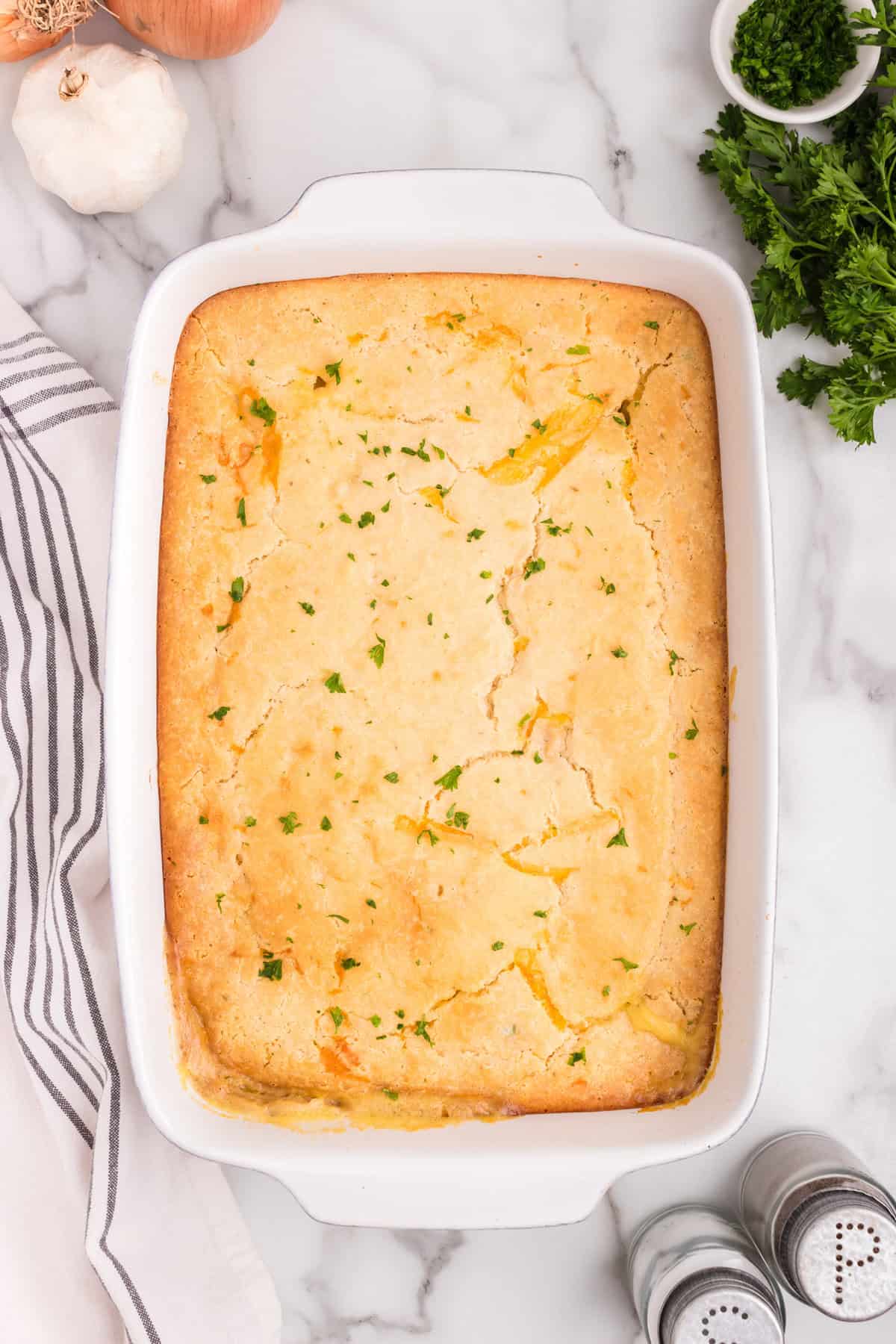 Overhead picture ofo white baking dish with completed chicken cobbler.