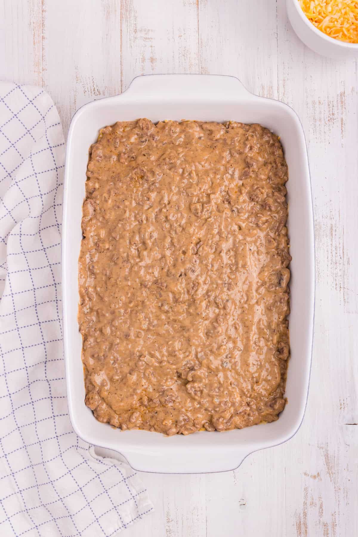 Overhead picture of white pan with ground beef mixture in it.
