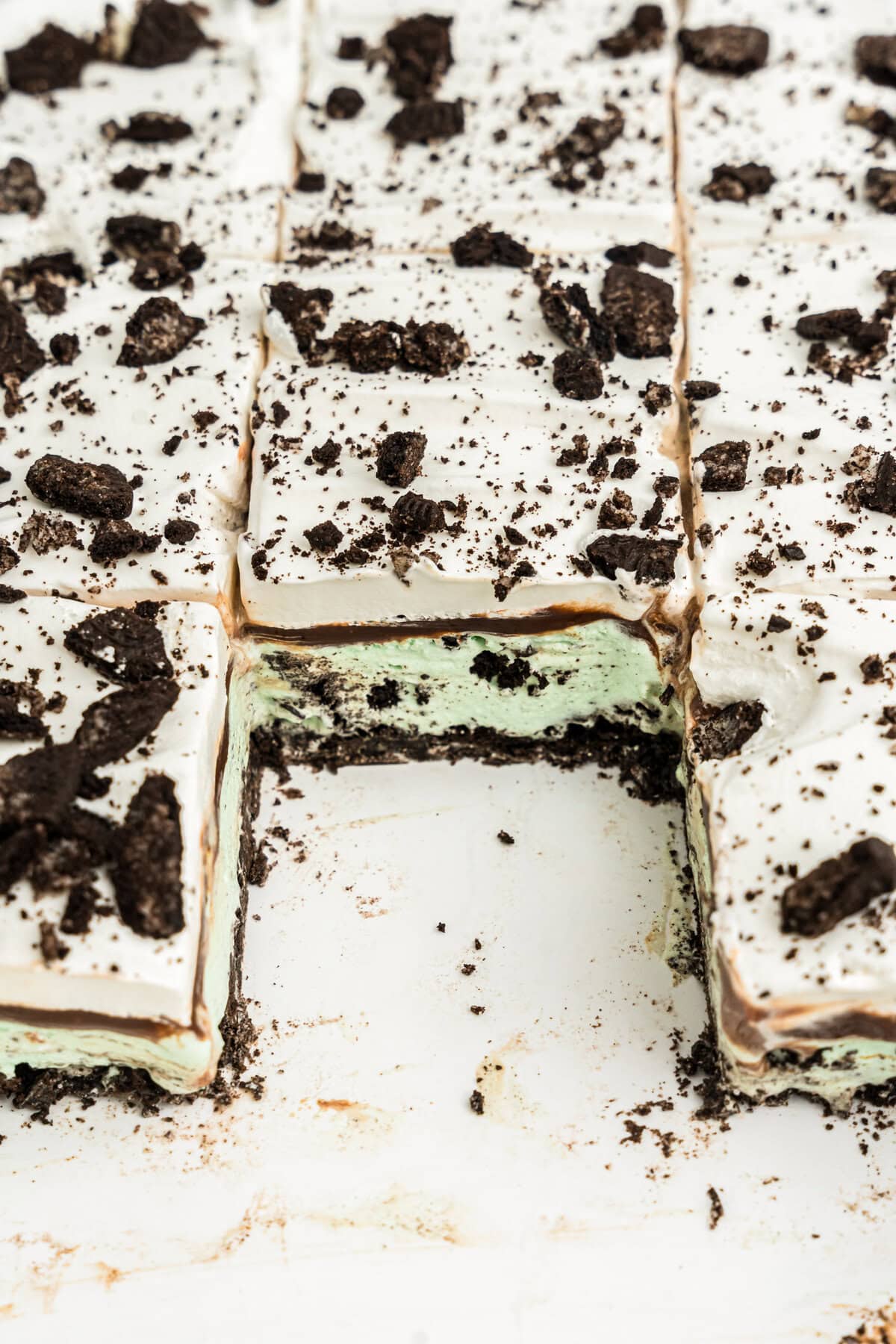 Mint Oreo Ice Cream Dessert layered picture with one piece cut out