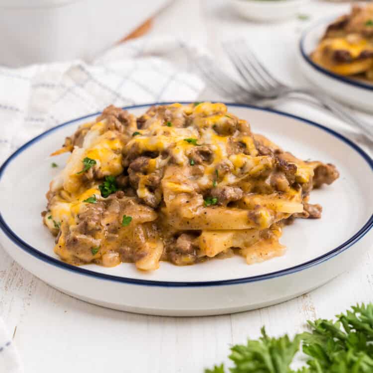 White plate with a serving of completed ground beef and potato casserole on it.