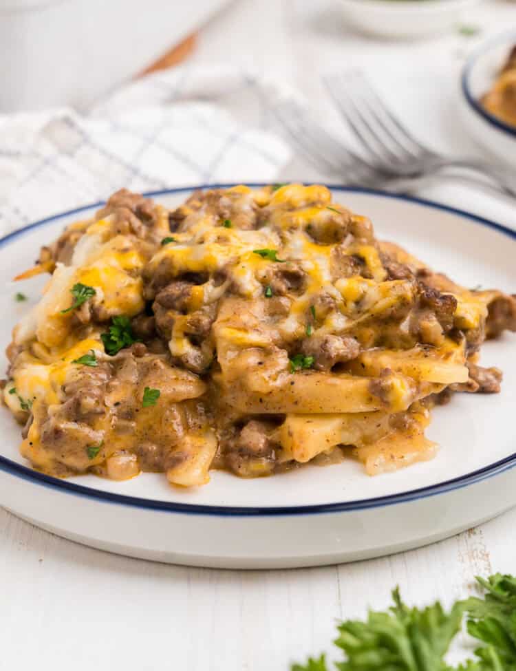 White plate with a serving of completed ground beef and potato casserole on it.