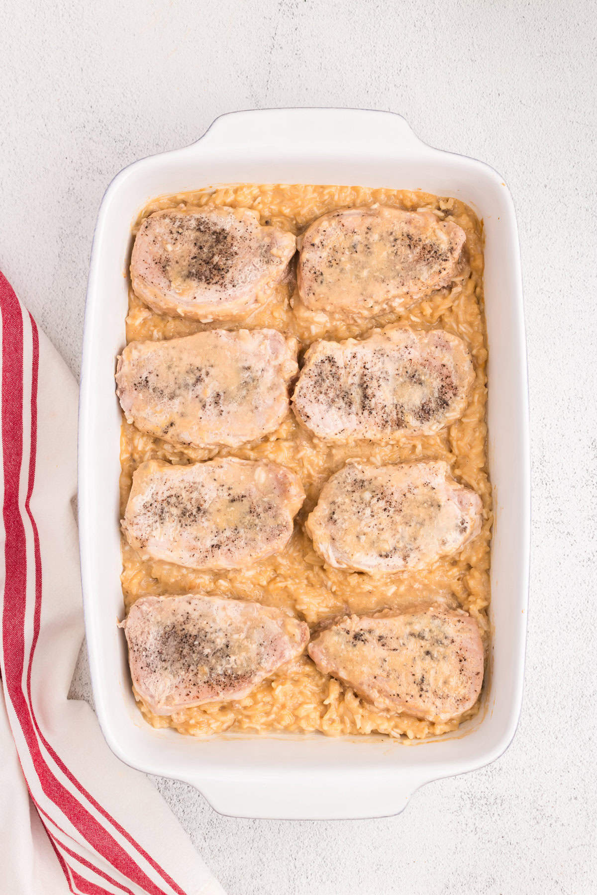 Baked Pork Chops and Rice hot out of the oven in baking dish