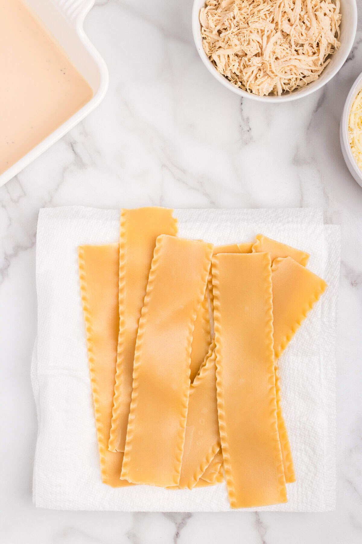 Cooked lasagna noodles on a paper towel