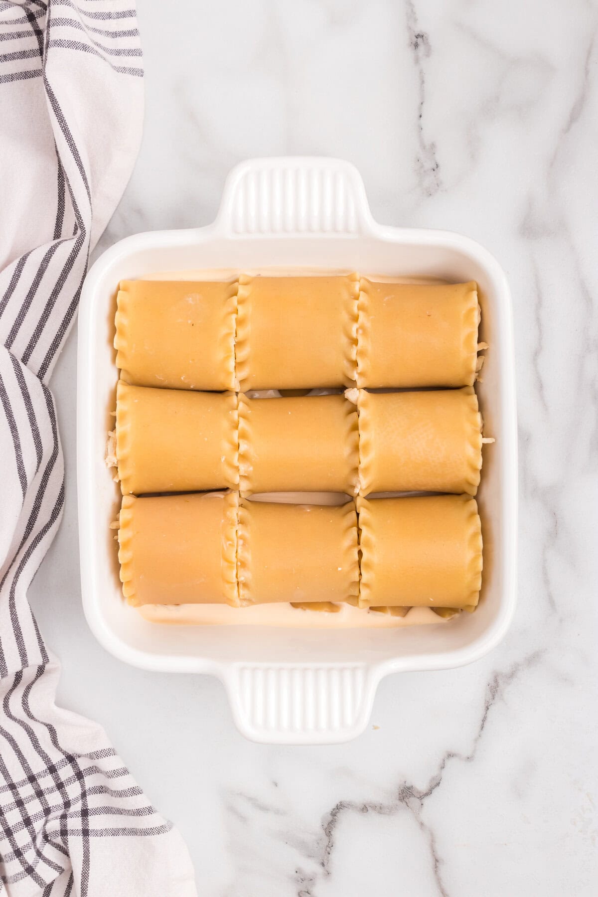 Overhead picture of roll ups in pan without sauce on it.