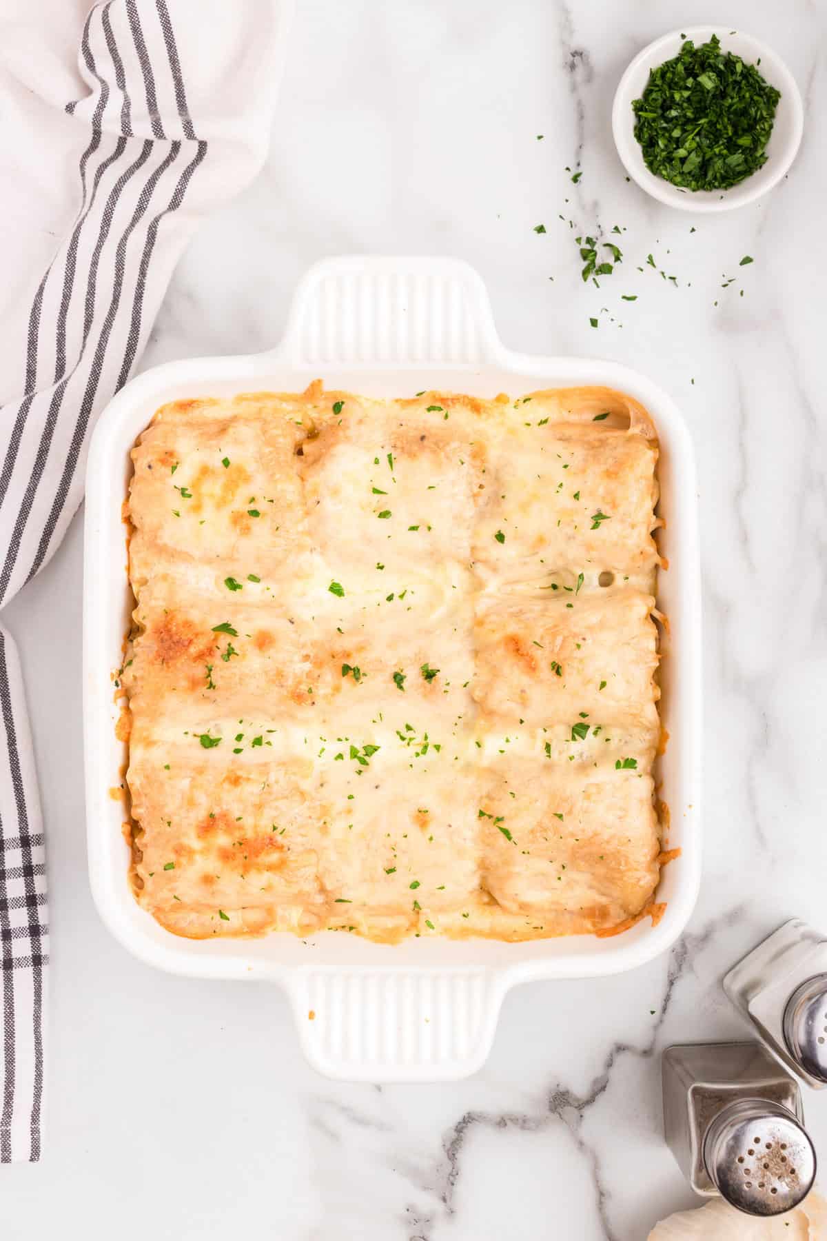 Completed Chicken Alfredo Roll ups in a white pan