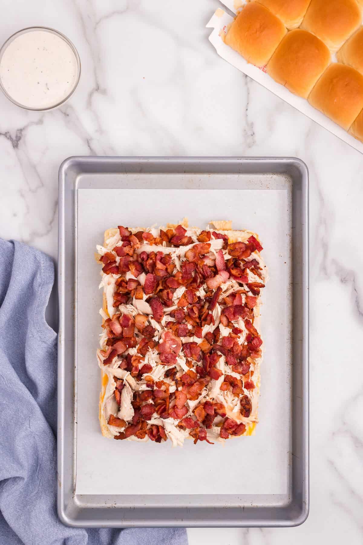 Overhead picture of bacon layered on sliders.
