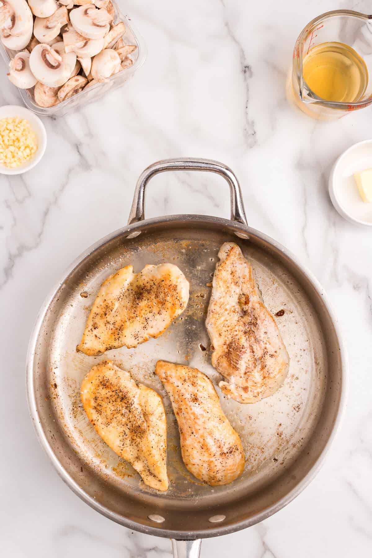 Cooking chicken breasts in stovetop skillet for Skillet Cream of Mushroom Chicken recipe