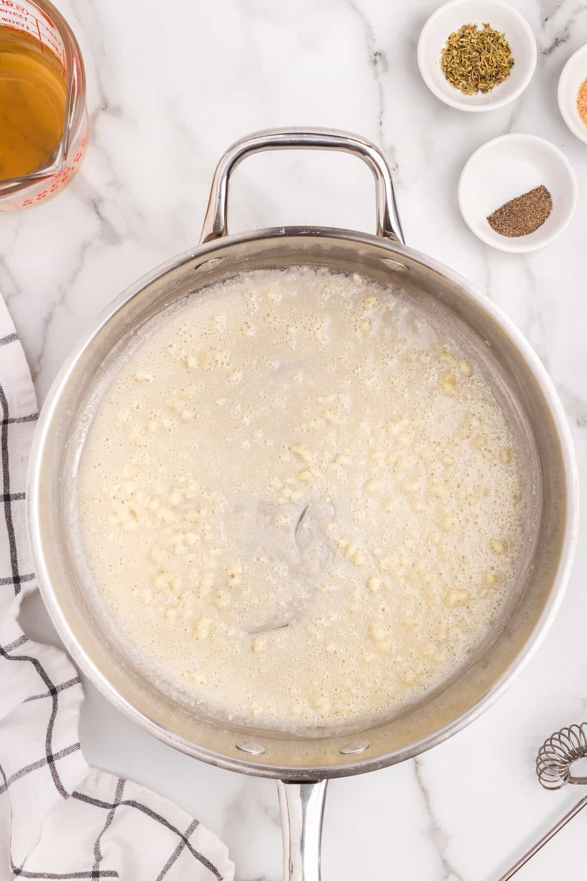 Metal pot with butter and garlic simmering