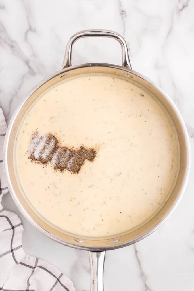Metal Pot with seasonings added to sauce