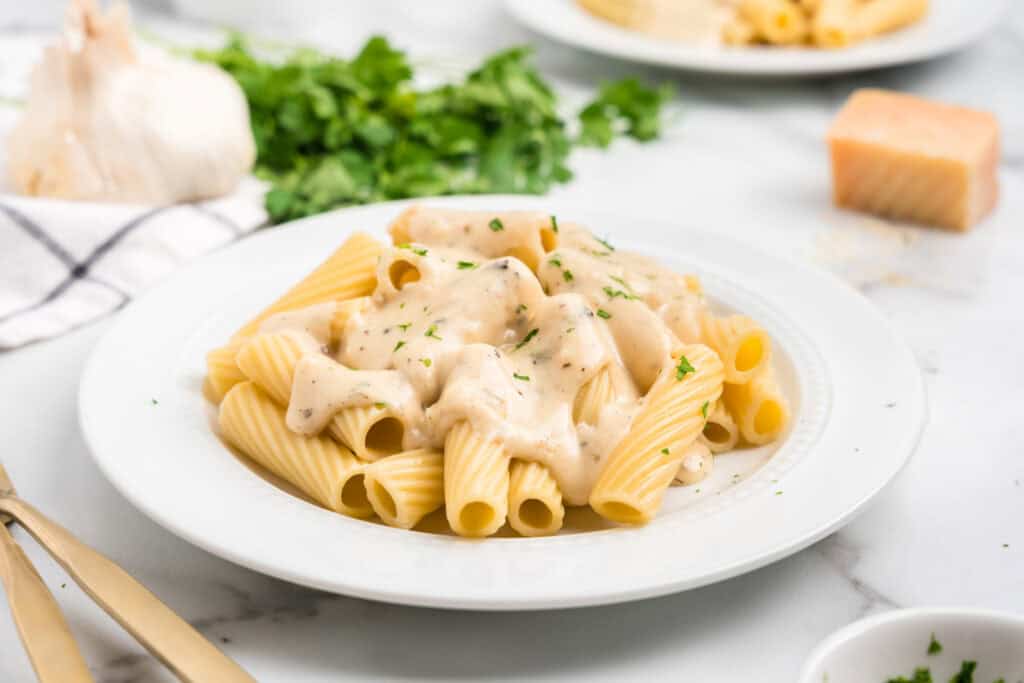 White plate with Garlic Parmesan Sauce on noodles