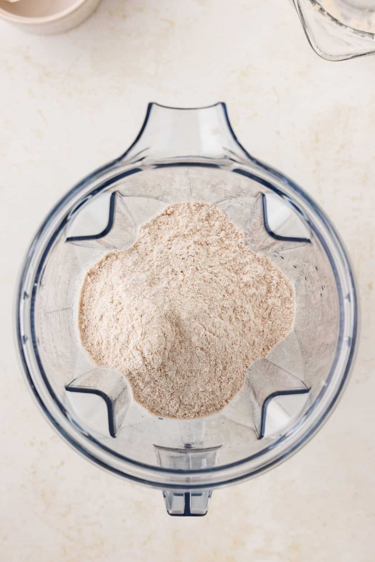 Blender with combined dry ingredients in it.