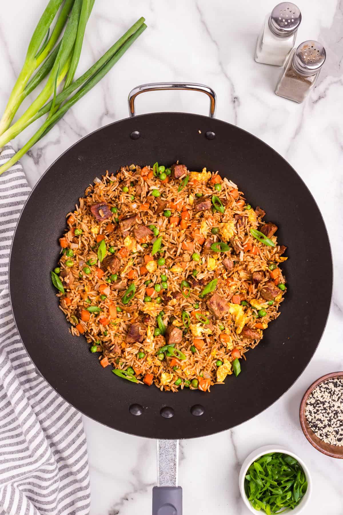 Overhead picture of black skillet pan with steak fried rice in it
