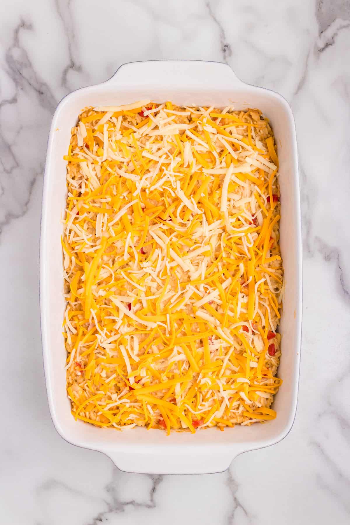 Overhead picture of unmelted cheese on the casserole.
