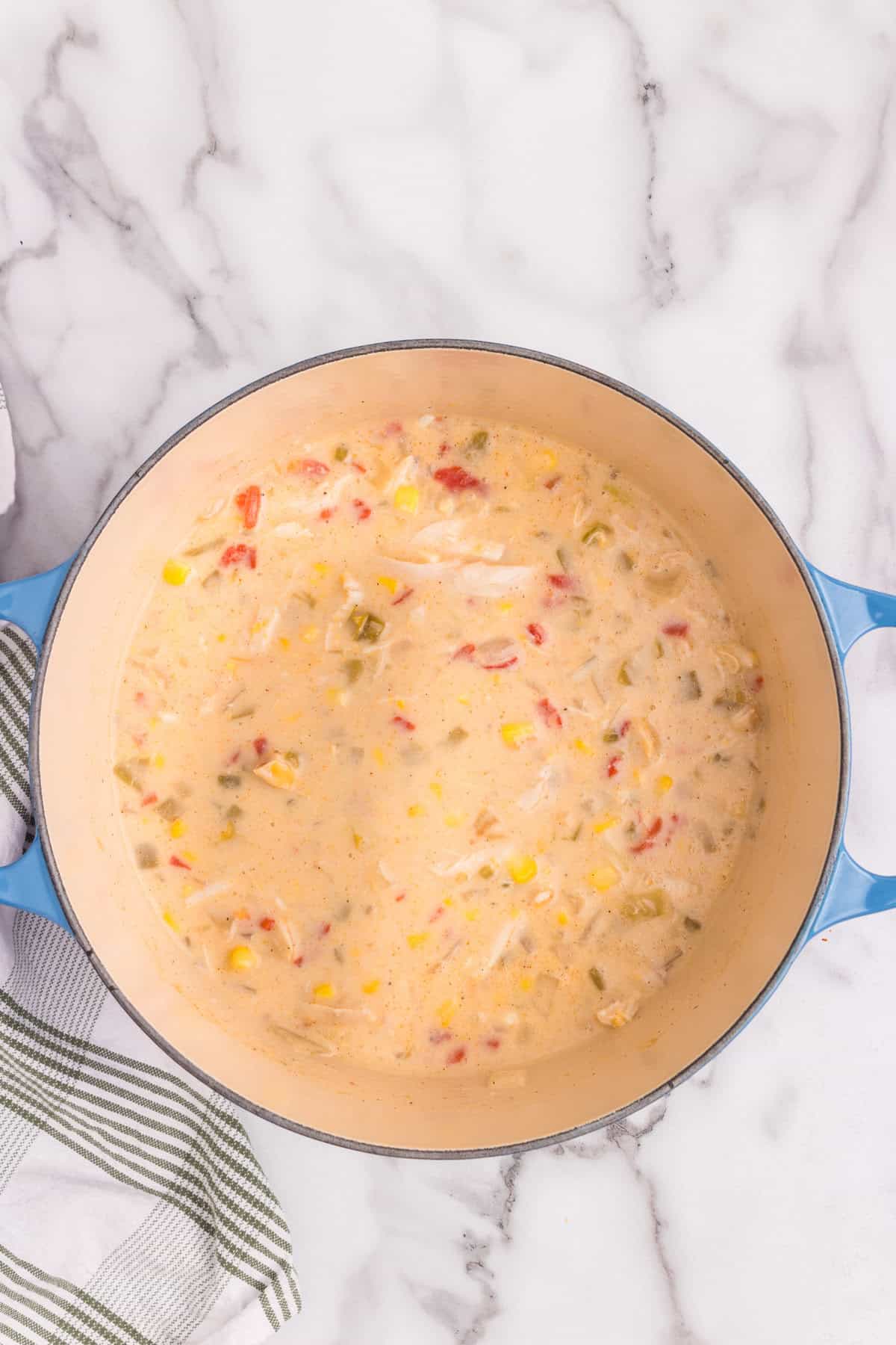 Overhead picture of completed chicken and corn chowder in a pot.