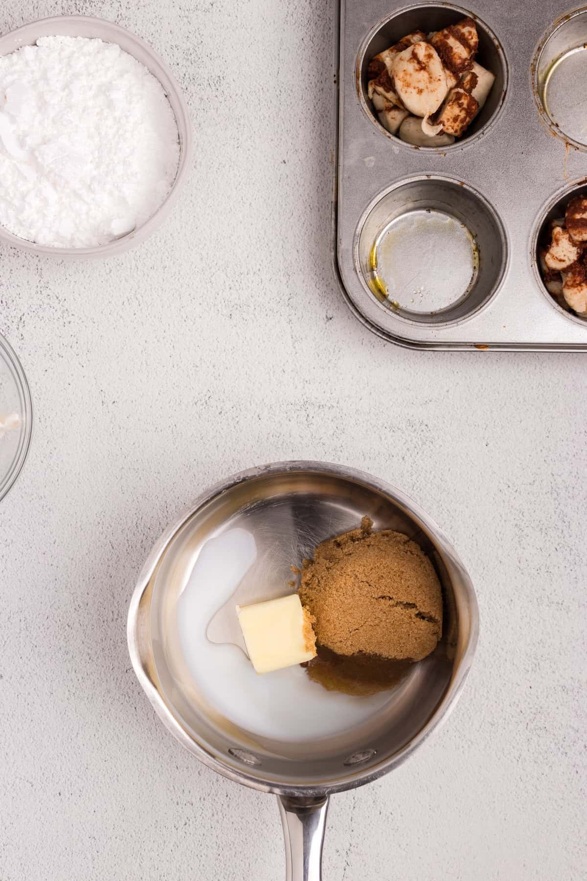 Overhead picture of metal bowl with brown sugar butter and powdered sugar in it.