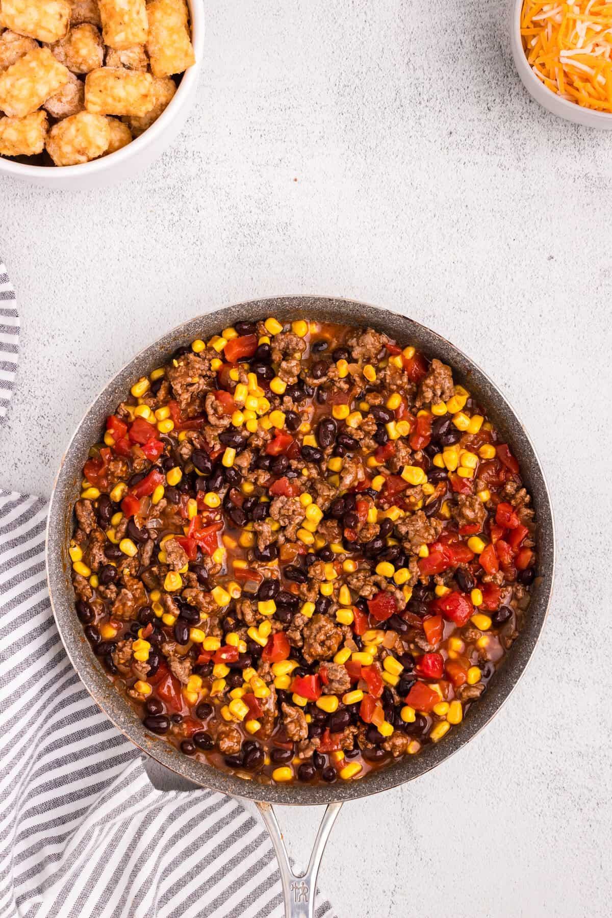 Overhead picture of a pan with combined Mexican Tater Tot Casserole ingredients in it.